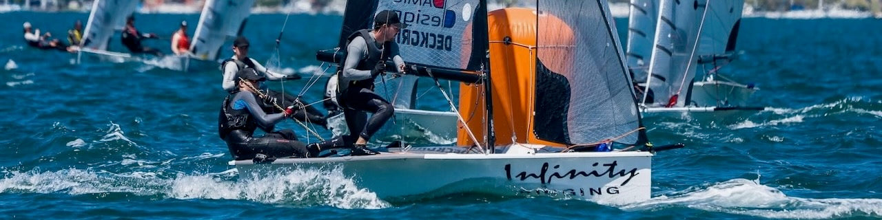 Sailboat with 'Infinity' branding on a body of water