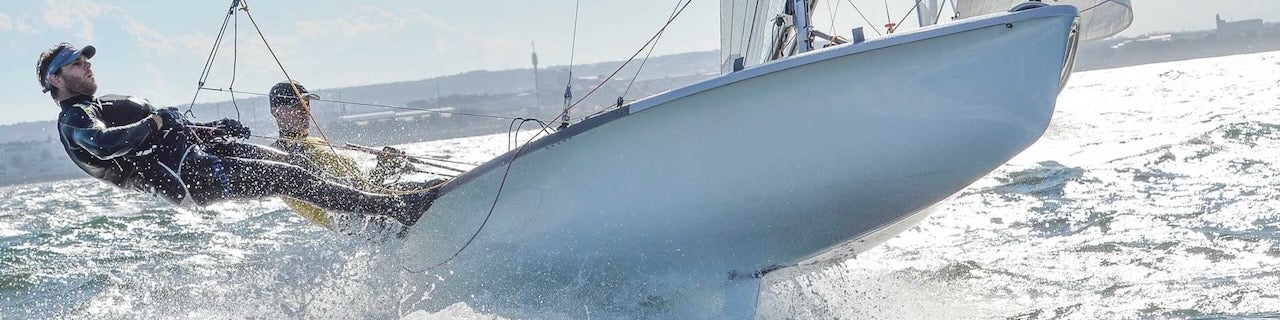 Photo of a 505 jumping off a wave.