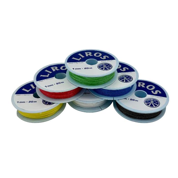 Set of colorful spools of LIROS thread on a white background